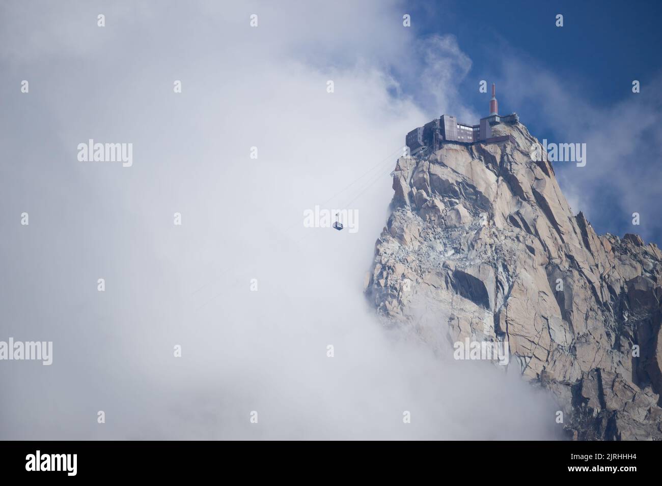 Aiguille du Midi cable car emerging from the fog Stock Photo