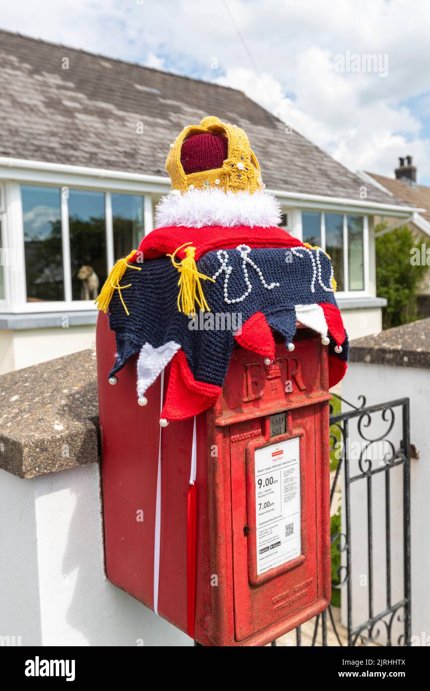 Red mailbox with a yarn crown Queen’s Platinum Jubilee, Mynachlog-ddu, Clynderwen, Wales Stock Photo