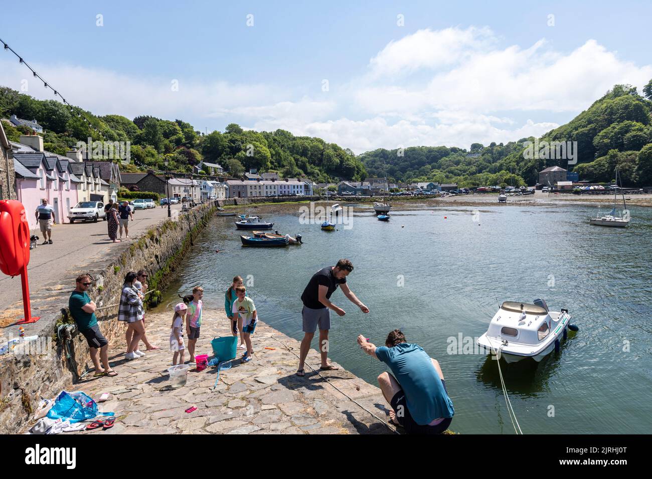 Family fishing in Quay st, Village of Fishguard, Pembrokeshire, Wales, UK Stock Photo