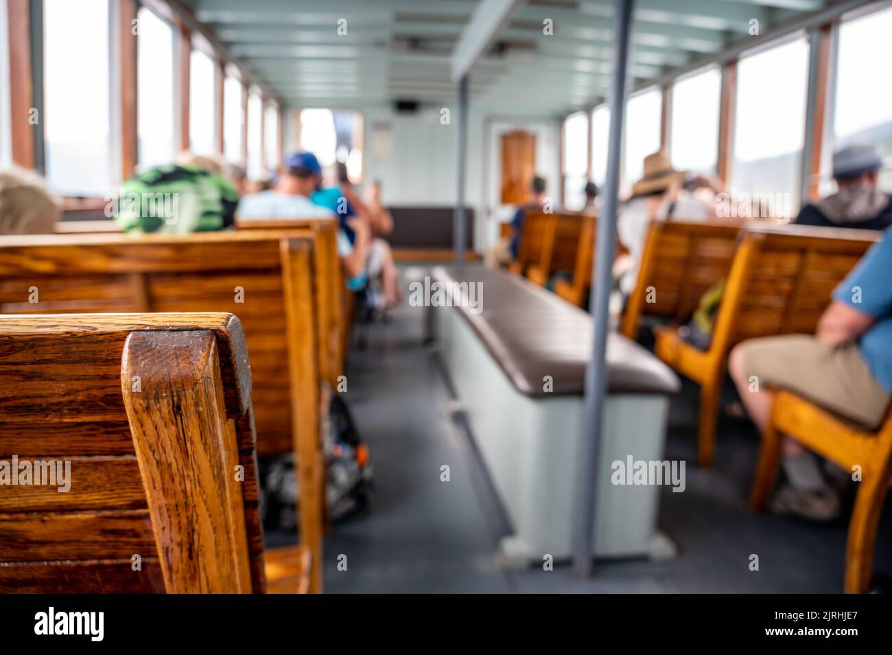 focus on wooden bench on a tour boat in Glacier National Park, Montana, USA Stock Photo
