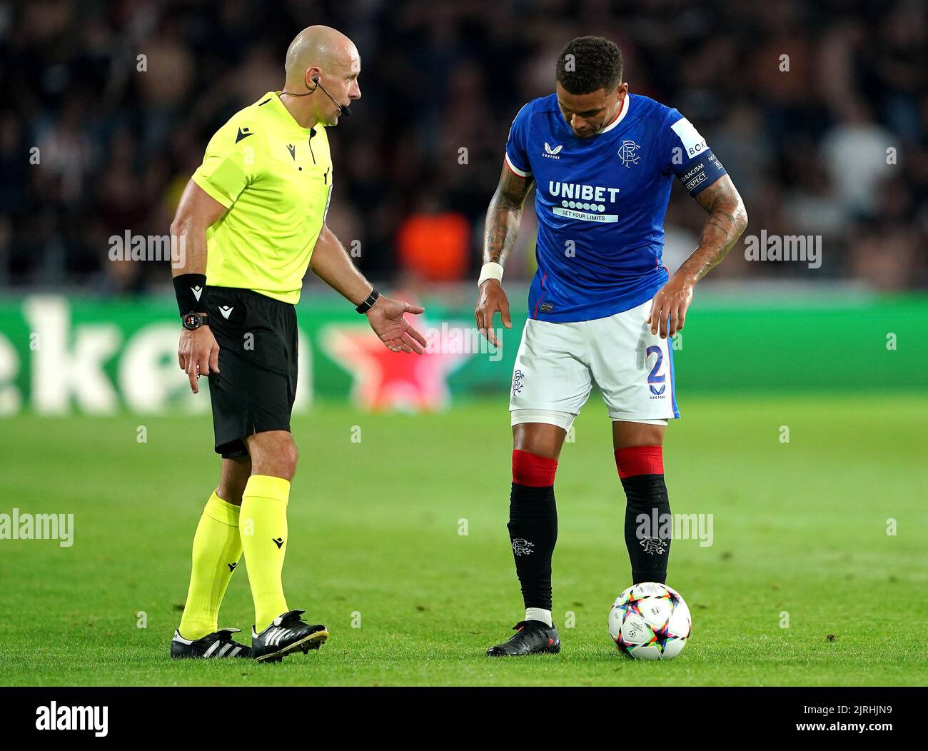 Rangers' James Tavernier (right) speaks to referee Szymon Marciniak during the UEFA Champions League qualifying match at PSV Stadion, Eindhoven. Picture date: Wednesday August 24, 2022. Stock Photo
