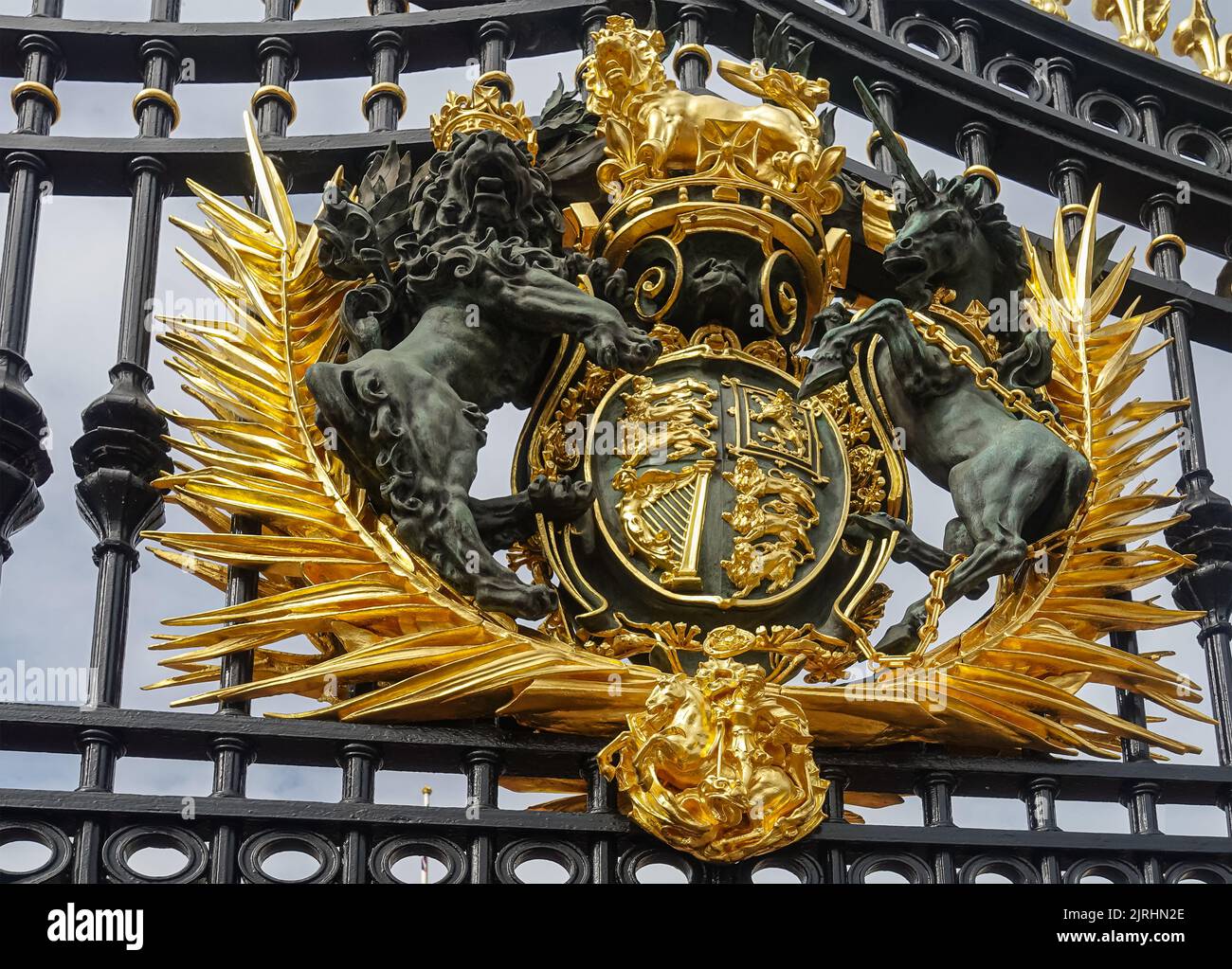 London, England, UK - July 6, 2022: Buckingham Palace. Fisheye closeup of golden royal coat of arms fixed to black metal main gate. Stock Photo