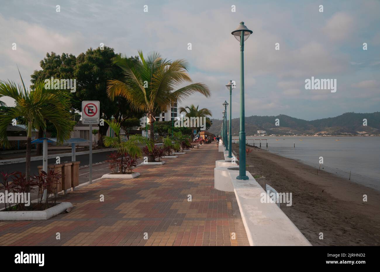 Bahia de Caraquez, Manabi / Ecuador - August 20 2022: People walking on the boardwalk of the city next to the beach on a cloudy day Stock Photo