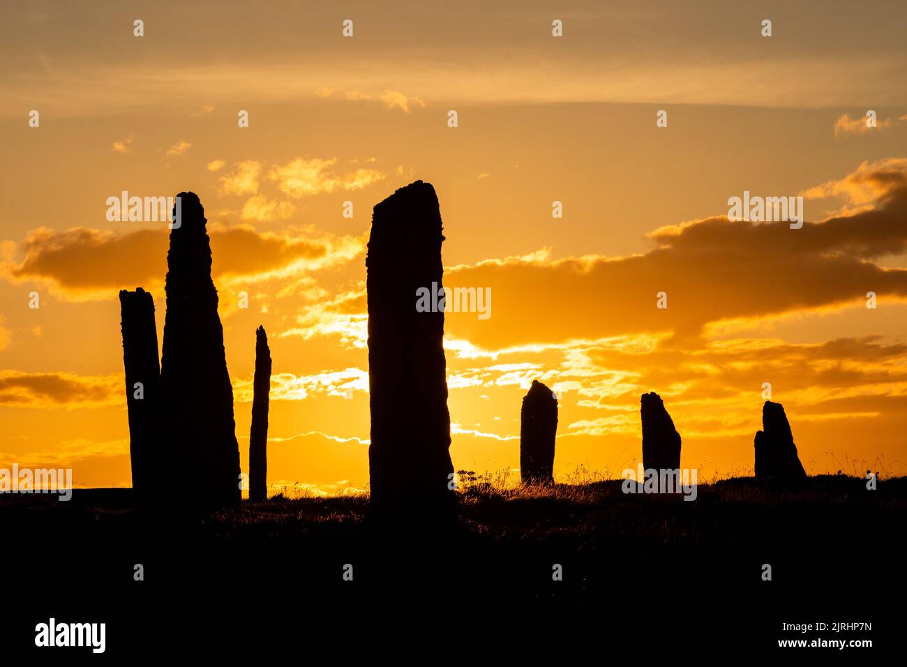 Orkney, UK. 24th Aug, 2022. The Ring of Brodgar, Orkney, looks dramatic as the sun sets. The 4,500 year old neolithic stone circle is part of the Heart of Neolithic Orkney World Heritage Site, and of the 60 original stones just 36 survive. Credit: Peter Lopeman/Alamy Live News Stock Photo