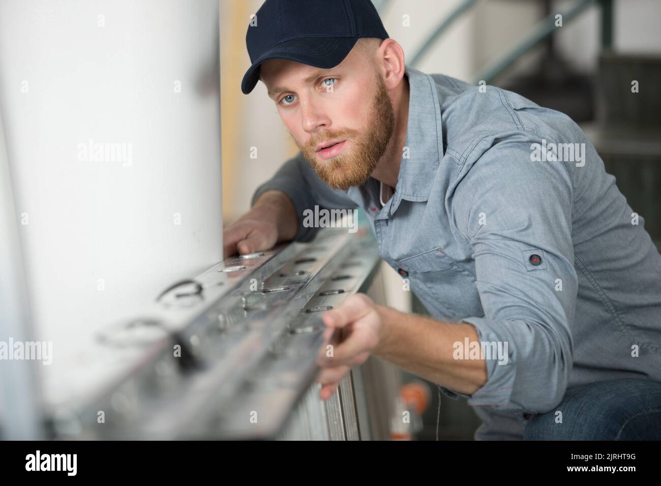 young man checking a ladder before Stock Photo