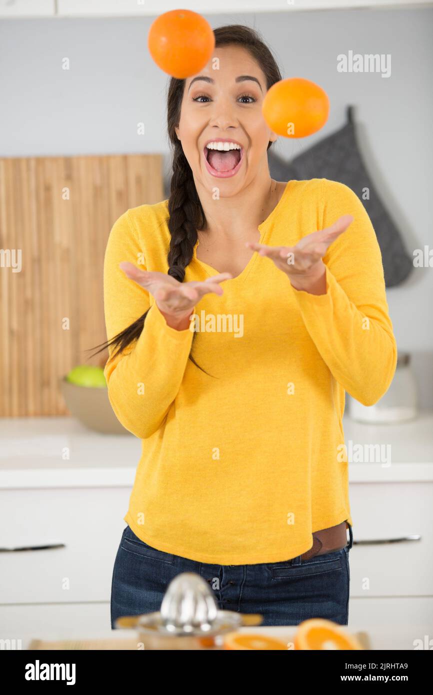 happy pretty woman juggling with oranges Stock Photo Alamy