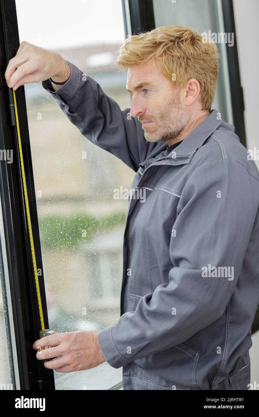 male hands making window measurements Stock Photo