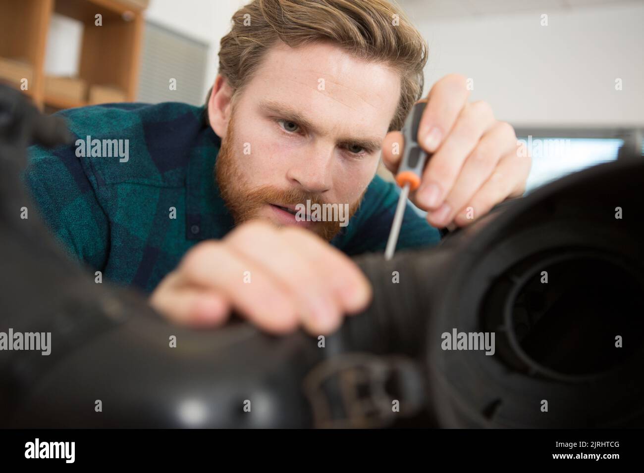 young man is assembling an office chair Stock Photo Alamy