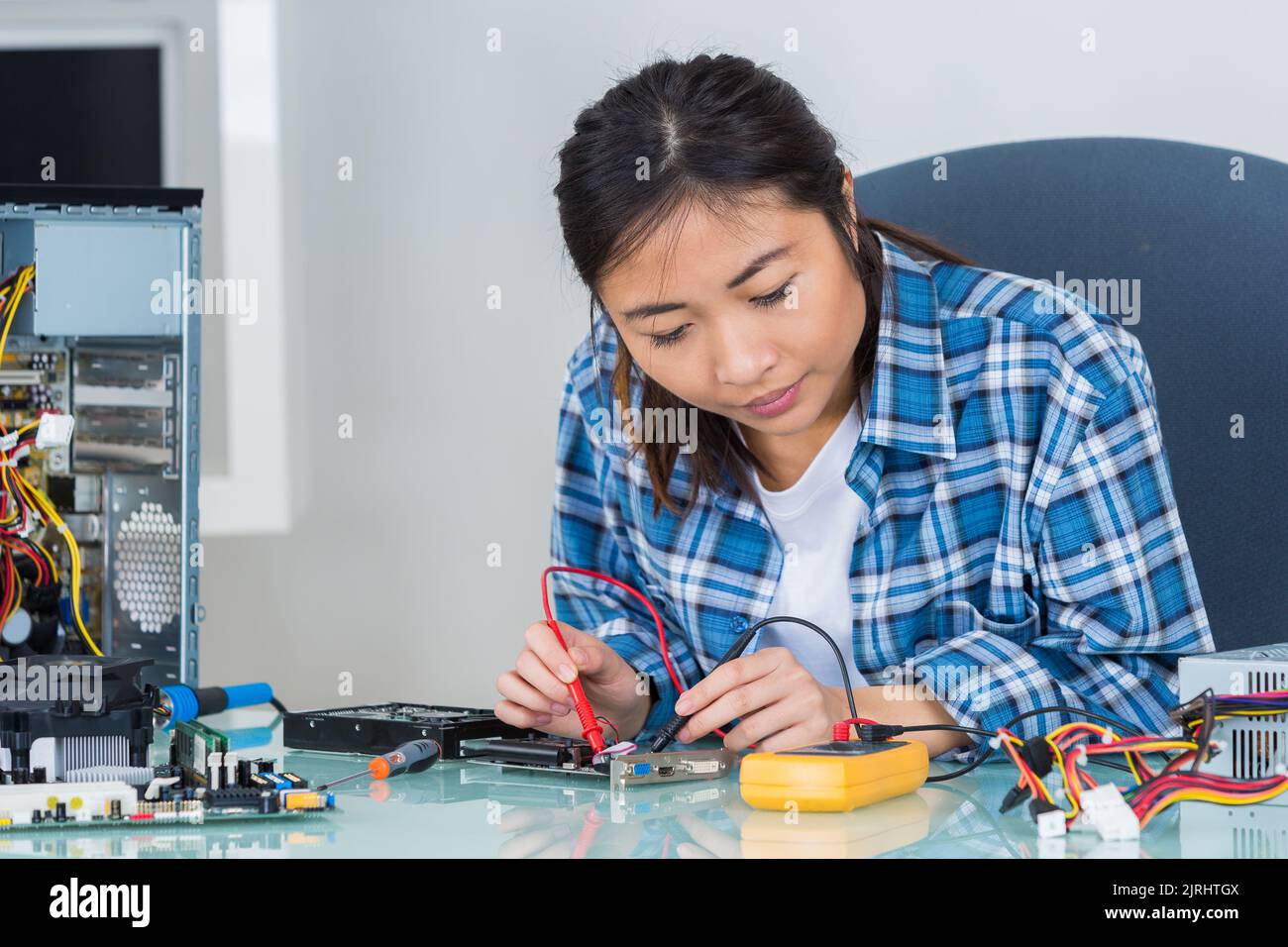 asian woman testing computer component with multimeter Stock Photo - Alamy