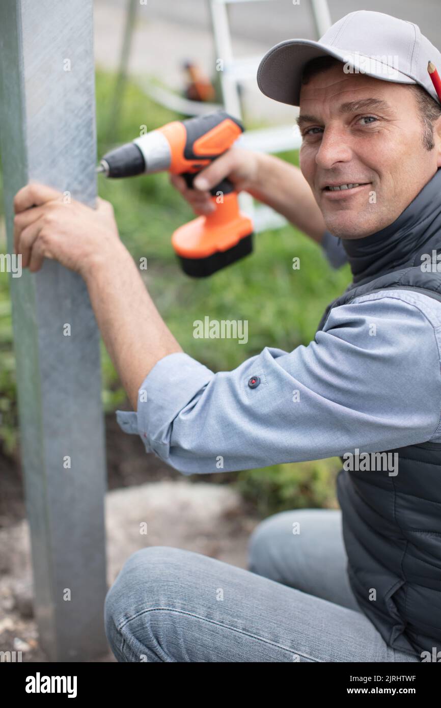handyman outdoors works with cordless screwdriver Stock Photo