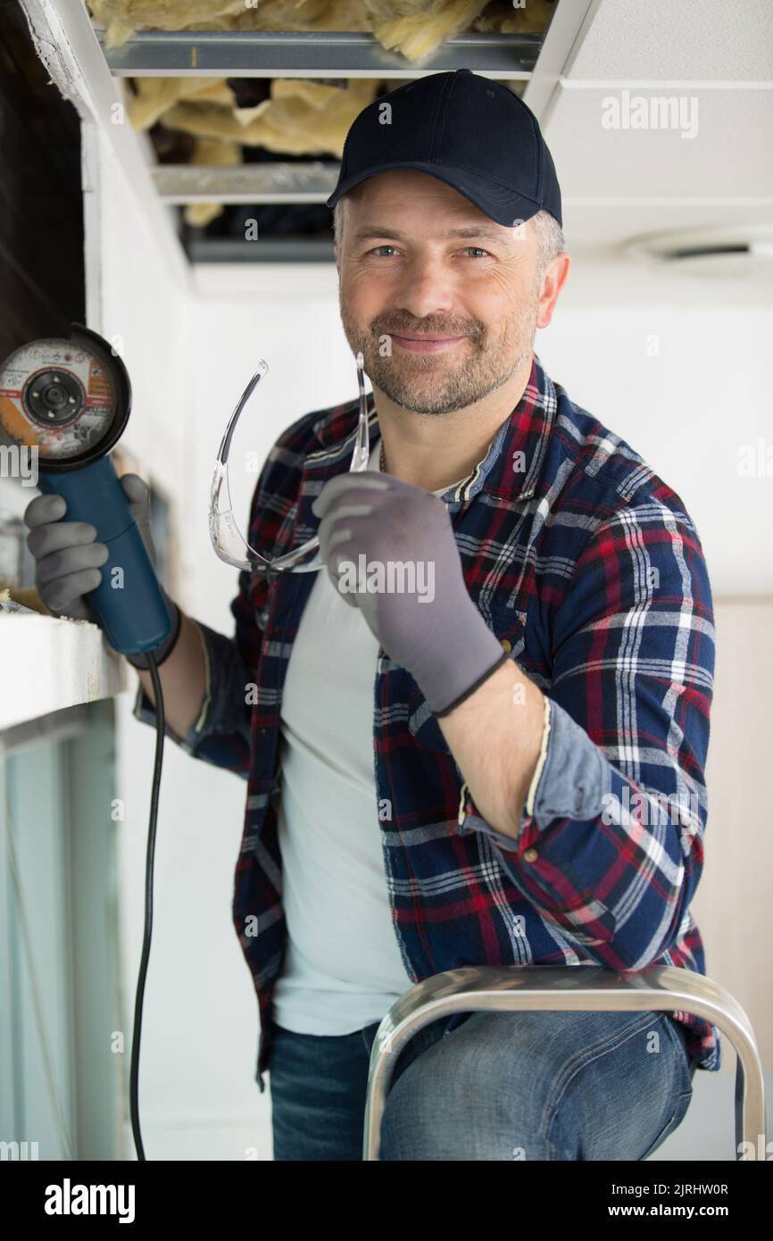 male contractor using angle grinder Stock Photo Alamy
