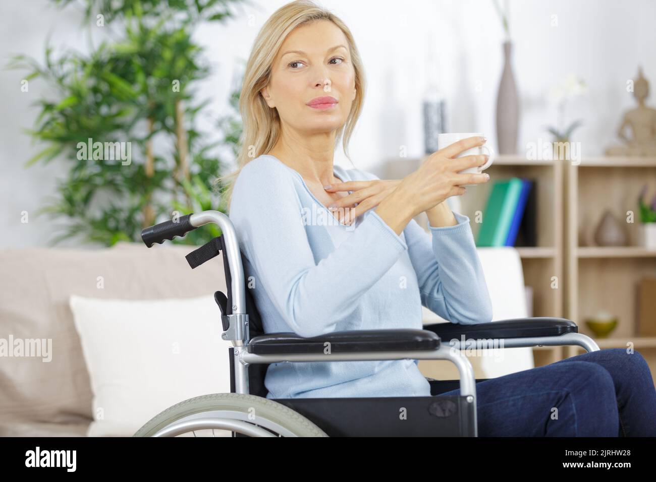 woman in wheelchair h at home Stock Photo