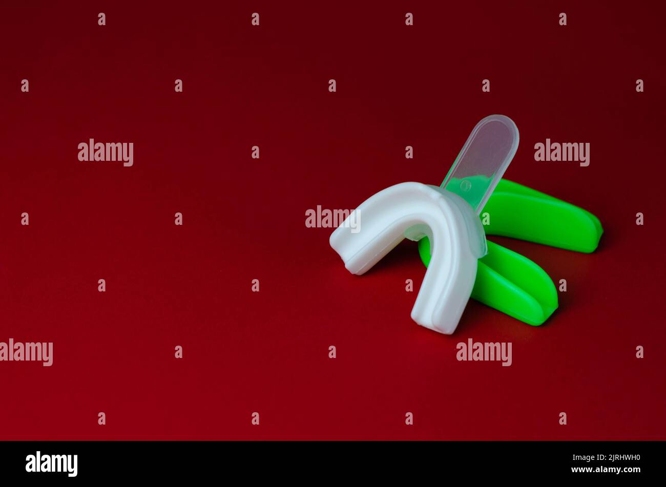 two rubber boxing mouth guards, white and green, protection for lips