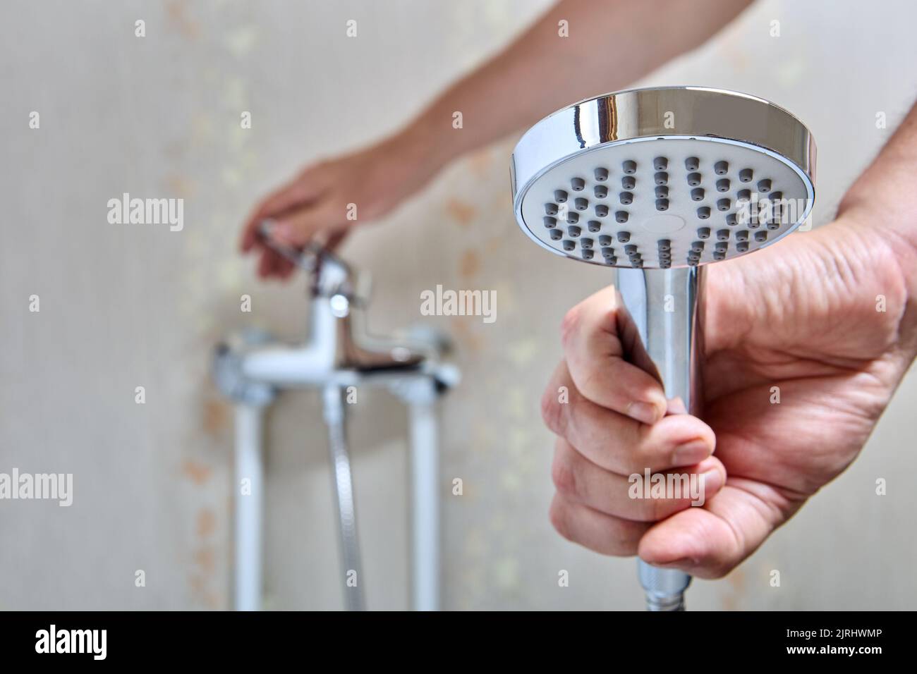 Plumber fixed leaking shower head on flexible hose Stock Photo Alamy