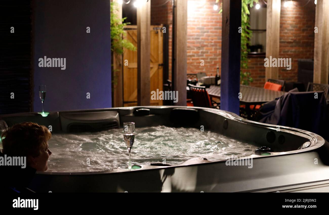 Relaxing  and soaking in a jacuzzi or whirlpool, outdoor hot tub spa Stock Photo