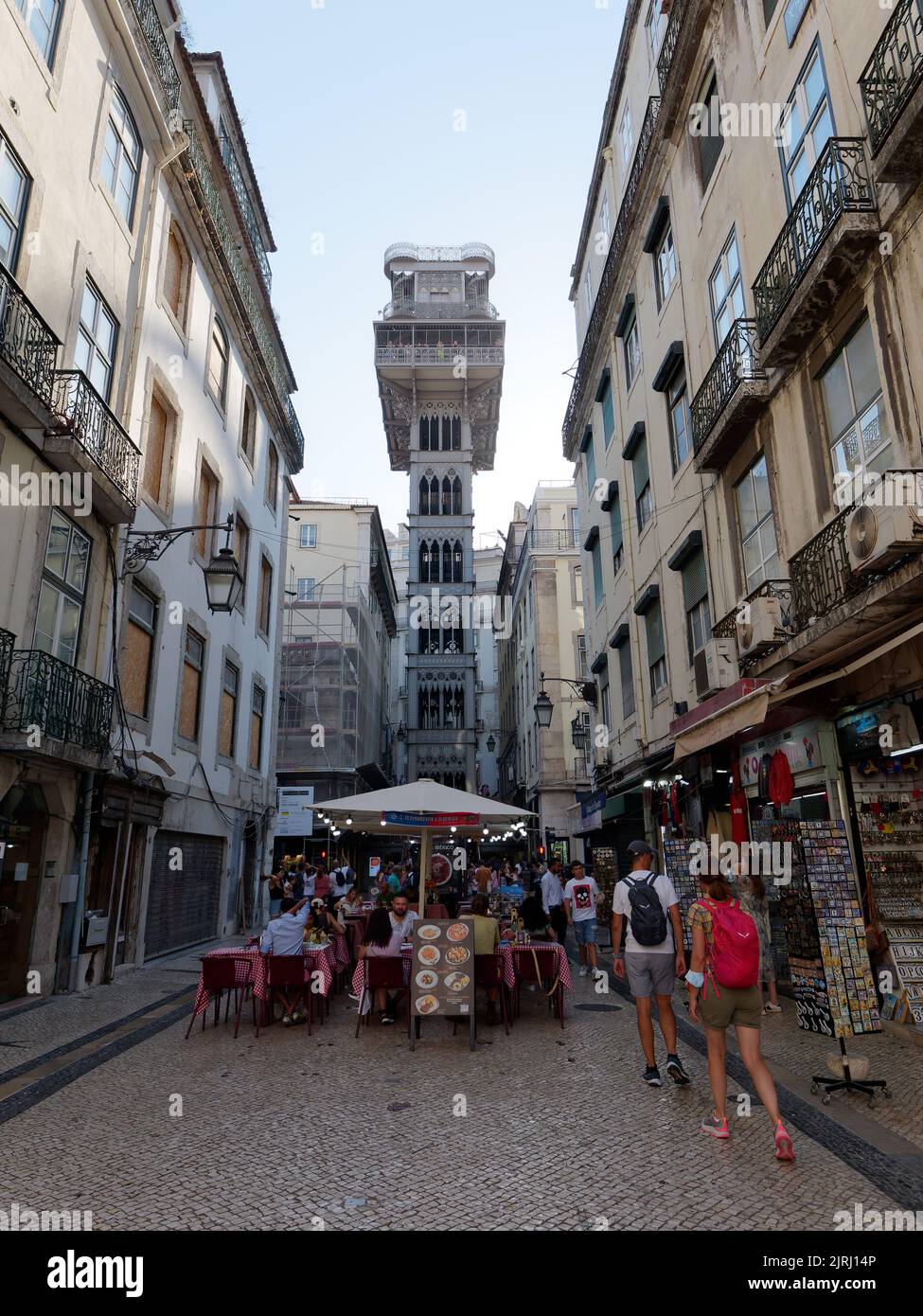 Santa Justa Lift in Lisbon, Portugal. Tourists walk the streets below and eat in the restaurants. Stock Photo