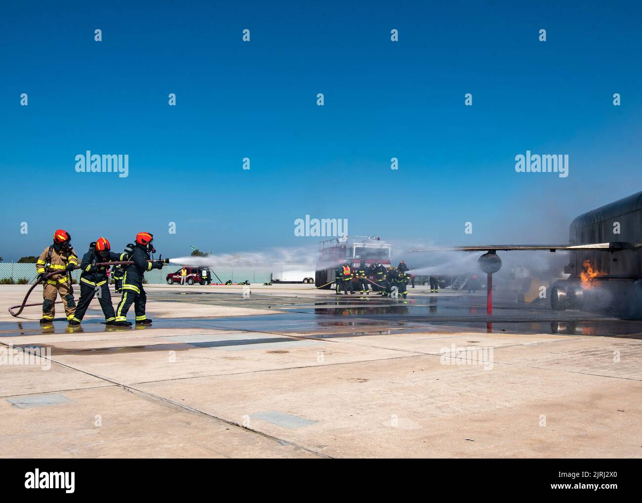 NAVAL STATION ROTA, Spain (Aug. 23, 2022) Naval Station (NAVSTA) Rota Fire and Emergency Services fight a fire from a simulated plane crash during a flight line emergency drill on NAVSTA Rota, Spain, Aug. 23, 2022. Naval Station Rota sustains the fleet, enables the fighter and supports the family by conducting air operations, port operations, ensuring security and safety, assuring quality of life and providing the core services of power, water, fuel and information technology. (U.S. Navy photo by Mass Communication Specialist 2nd Class Jacob Owen.) Stock Photo