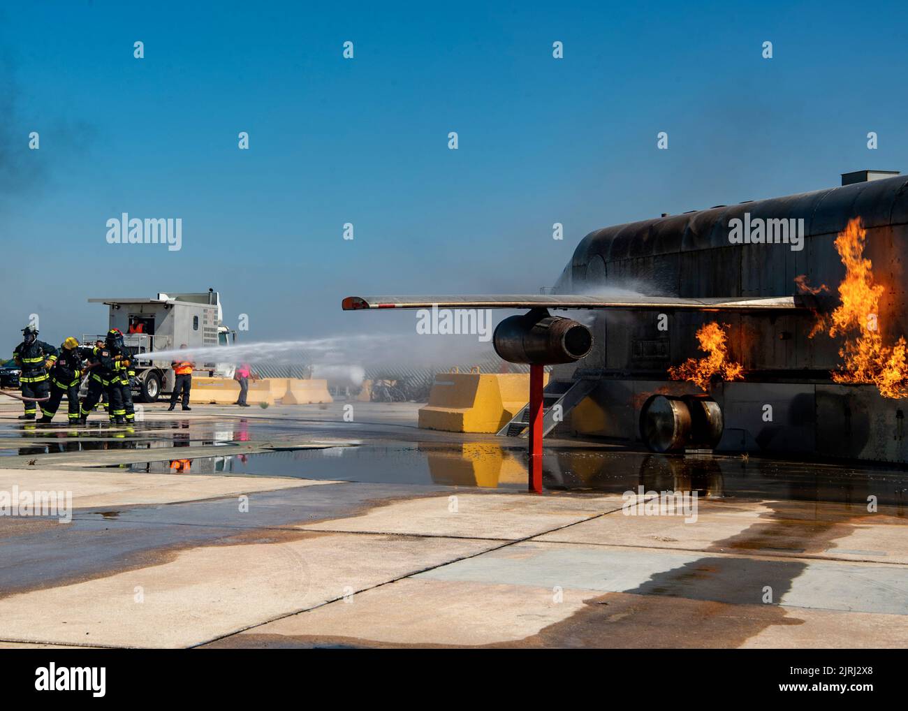 NAVAL STATION ROTA, Spain (Aug. 23, 2022) Naval Station (NAVSTA) Rota Fire and Emergency Services fight a fire from a simulated plane crash during a flight line emergency drill on NAVSTA Rota, Spain, Aug. 23, 2022. Naval Station Rota sustains the fleet, enables the fighter and supports the family by conducting air operations, port operations, ensuring security and safety, assuring quality of life and providing the core services of power, water, fuel and information technology. (U.S. Navy photo by Mass Communication Specialist 2nd Class Jacob Owen.) Stock Photo