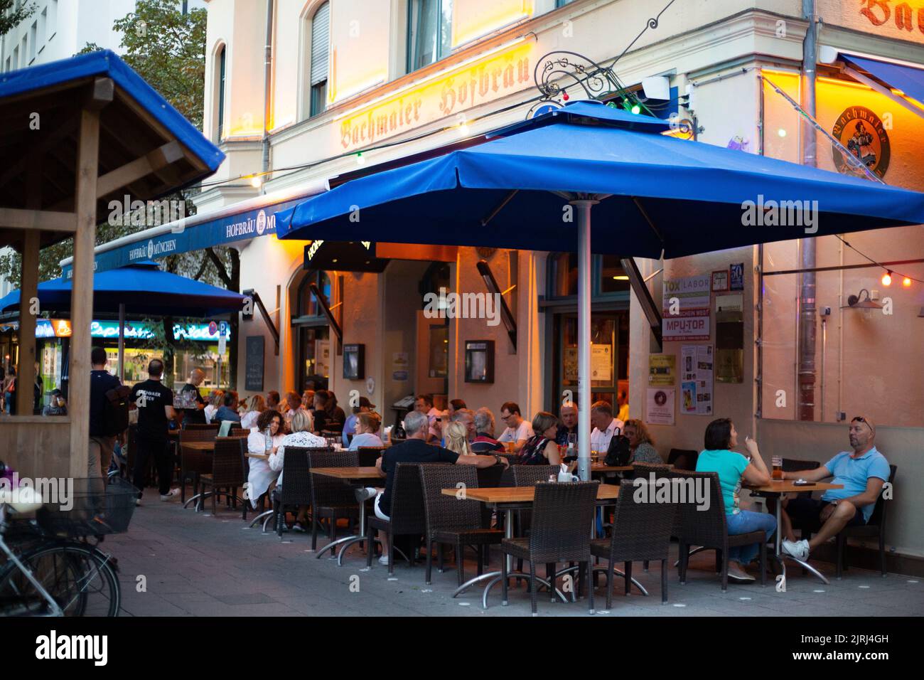 The people enjoy the summer evening in Cafés, Bars, Restaurants and in