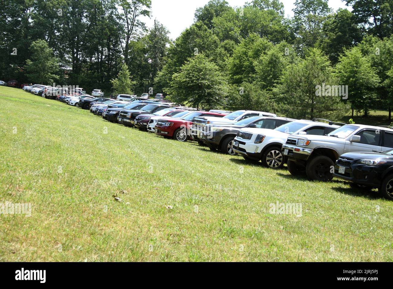 Vehicles parked on the grass during event in Virginia's countryside, USA Stock Photo