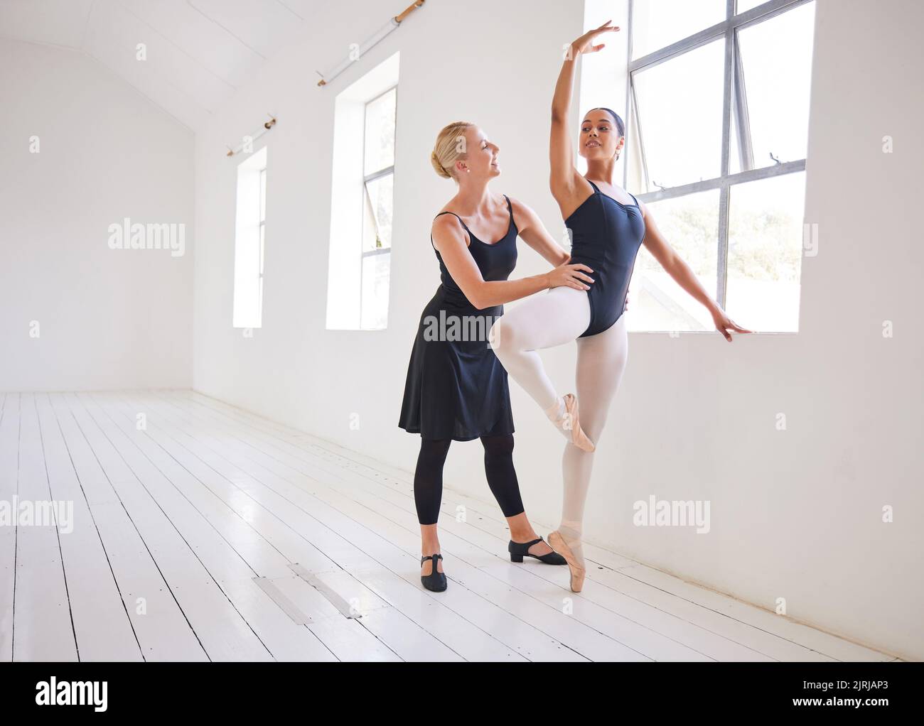 Ballet teacher, dancer and student training in a dance studio together. Fitness, learning and