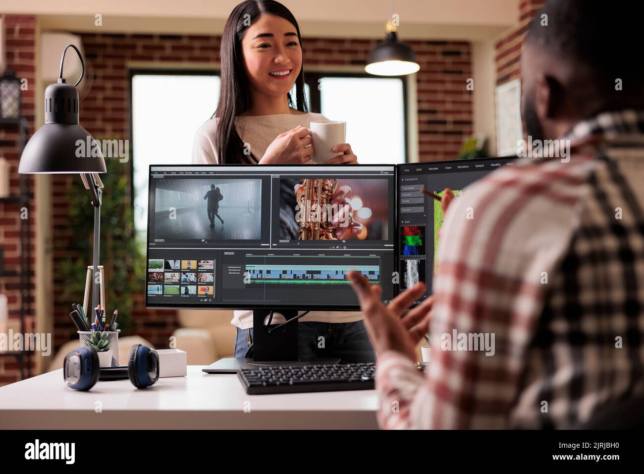 People videographers editing film footage on computer, using movie making software with visual and sound effects. Working on post production montage to make creative content on app. Stock Photo