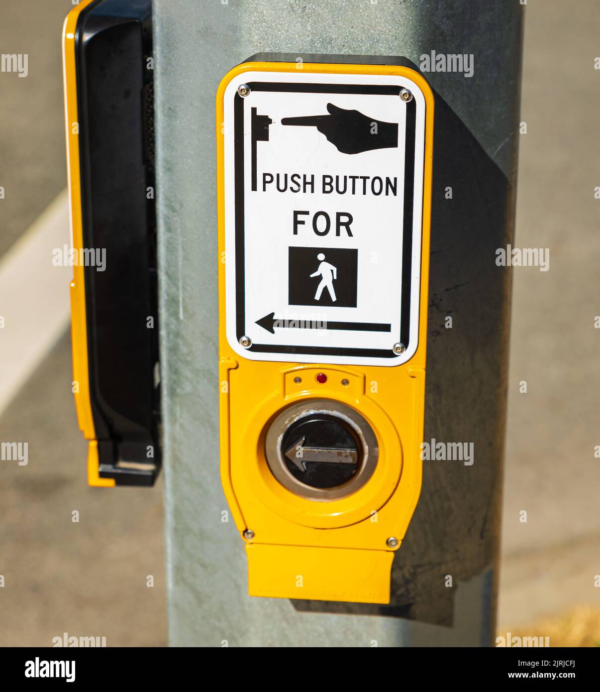 Push button for crosswalk sign. Crosswalk button and sign on street pole. Traffic control. Safely cross a road. Nobody, selective focus, street photo Stock Photo