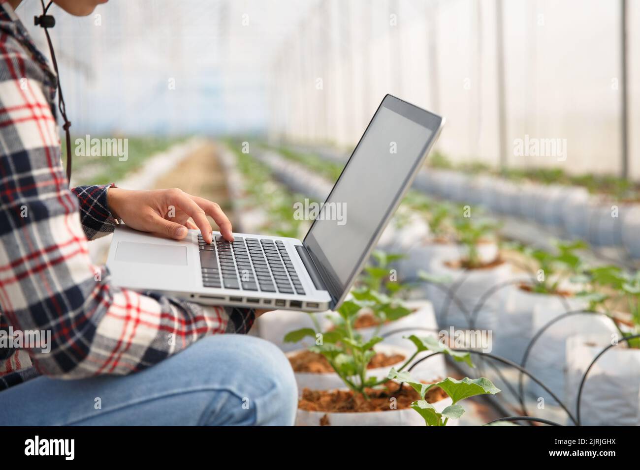 Agriculture technology concept man Agronomist Using a Laptop in an ...