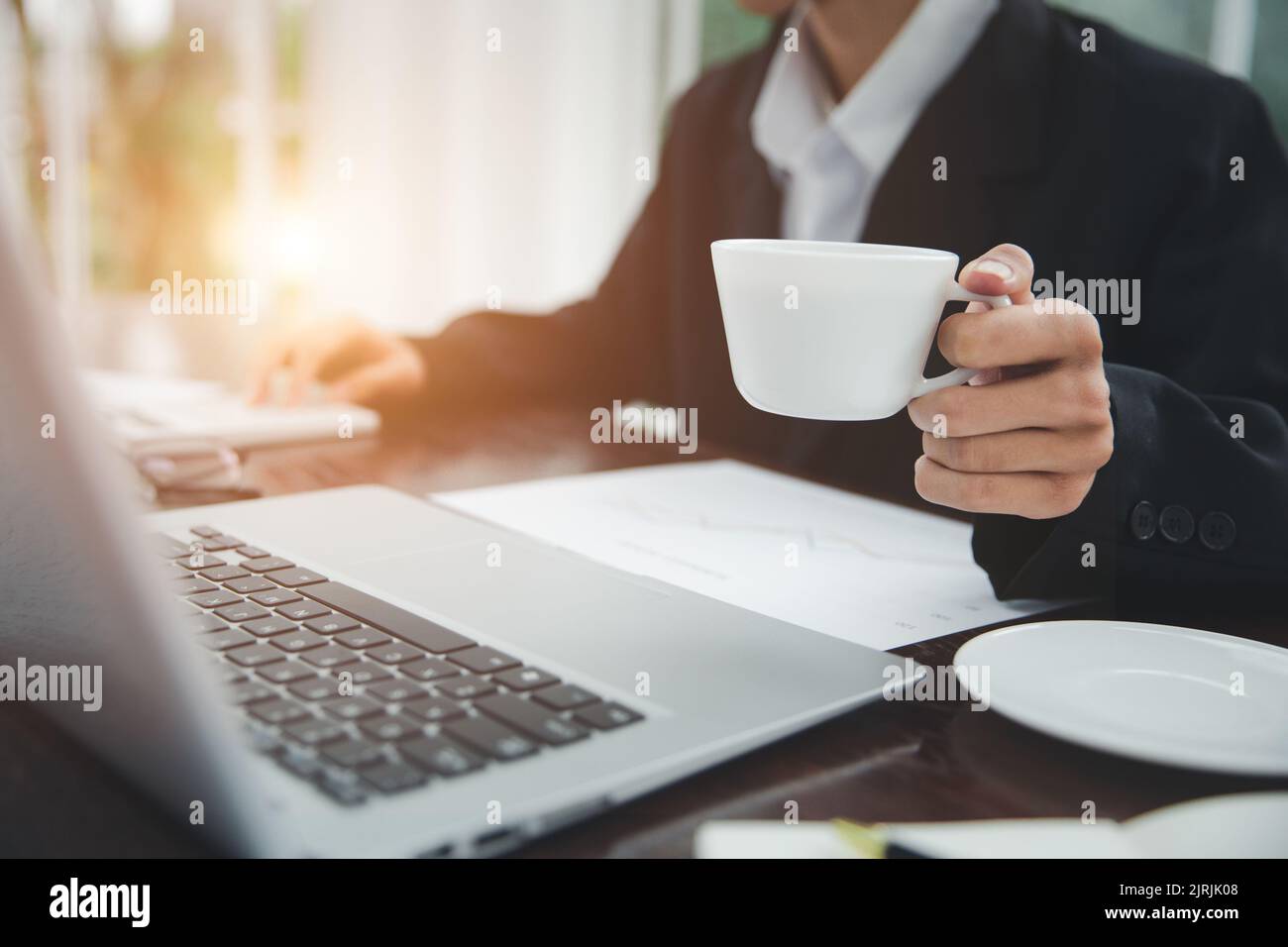 Young Businessman Analyzing Graph On Computer At Workplace Stock Photo
