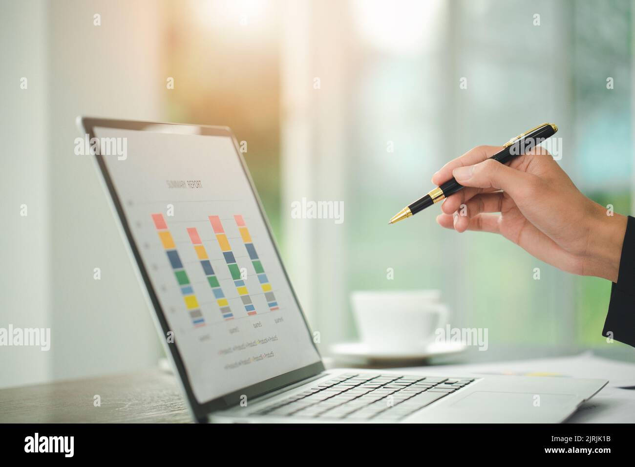 Young Businessman Analyzing Graph On Computer At Workplace Stock Photo