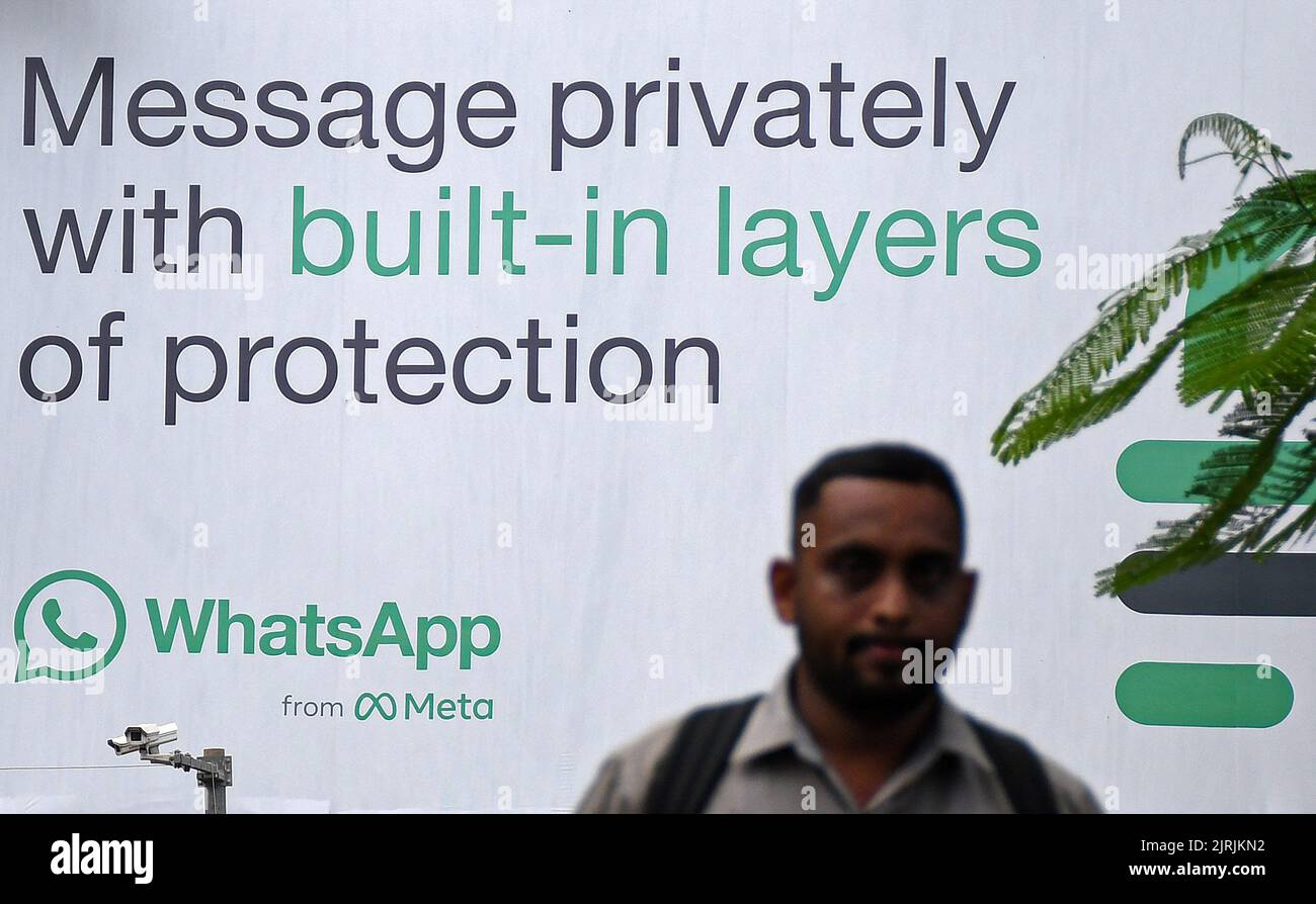 Mumbai, India. 24th Aug, 2022. A man walks in front of the WhatsApp logo displayed on a hoarding in Mumbai. WhatsApp is an instant messenger and voice over internet protocol owned by American company Meta that lets people connect with each other for casual or business related networking across the world. Credit: SOPA Images Limited/Alamy Live News Stock Photo