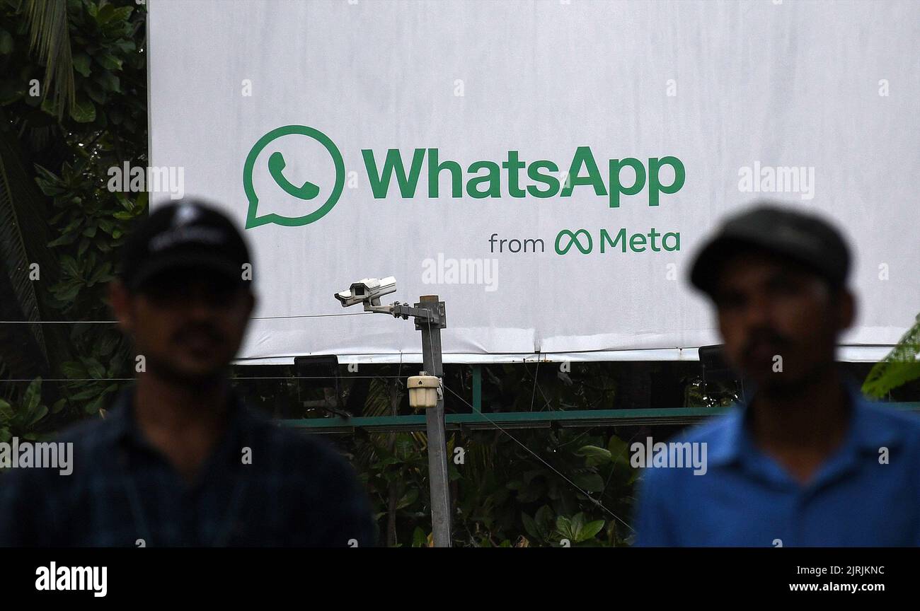 Mumbai, India. 24th Aug, 2022. Men walk in front of WhatsApp logo displayed on a hoarding in Mumbai. WhatsApp is an instant messenger and voice over internet protocol owned by American company Meta that lets people connect with each other for casual or business related networking across the world. Credit: SOPA Images Limited/Alamy Live News Stock Photo