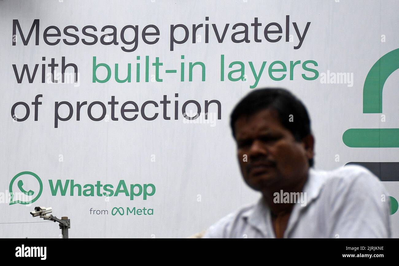 Mumbai, India. 24th Aug, 2022. A man walks in front of the WhatsApp logo displayed on a hoarding in Mumbai. WhatsApp is an instant messenger and voice over internet protocol owned by American company Meta that lets people connect with each other for casual or business related networking across the world. Credit: SOPA Images Limited/Alamy Live News Stock Photo