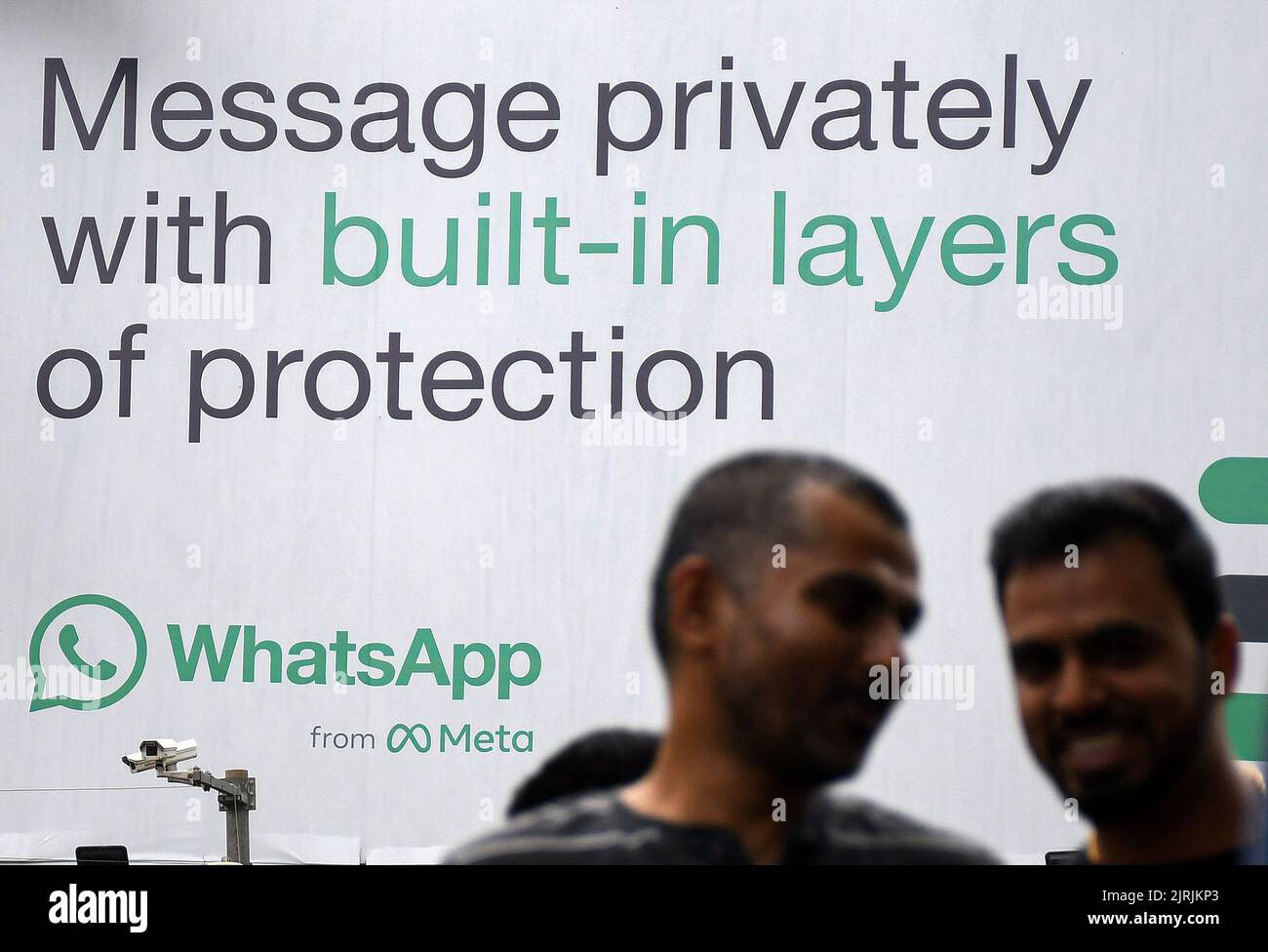 Mumbai, India. 24th Aug, 2022. Men walk in front of WhatsApp logo displayed on a hoarding in Mumbai. WhatsApp is an instant messenger and voice over internet protocol owned by American company Meta that lets people connect with each other for casual or business related networking across the world. Credit: SOPA Images Limited/Alamy Live News Stock Photo