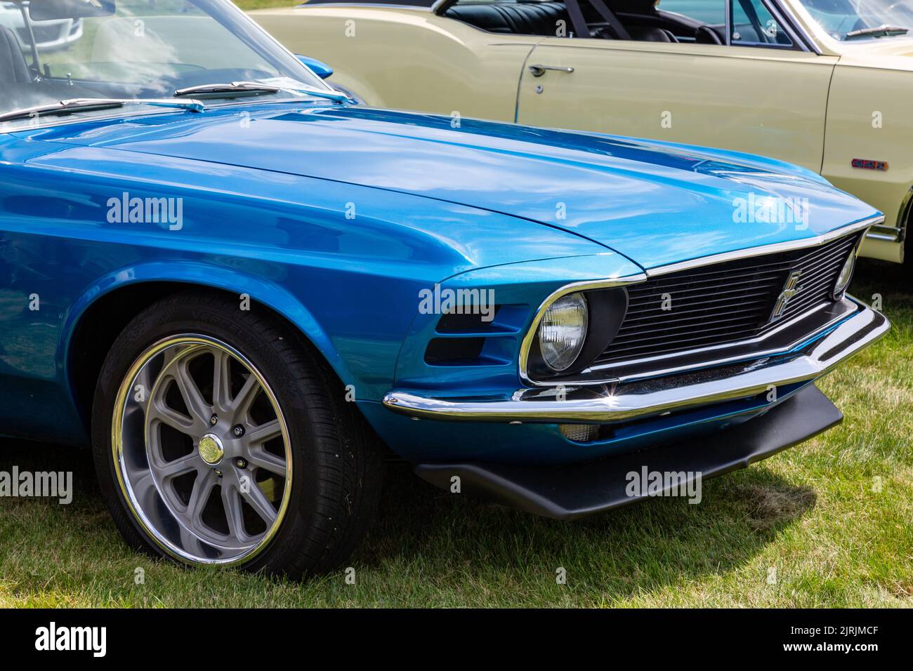 A classic blue 1970 Ford Mustang on display at a car show in Fort Wayne
