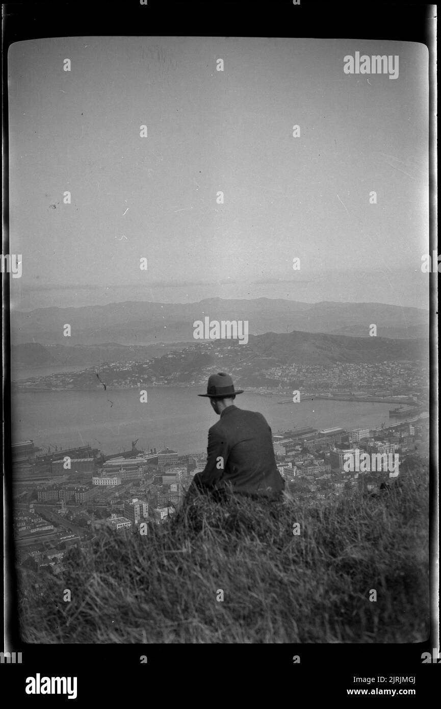 [Man looking over Wellington harbour], 1920s-1930s, Wellington, by Roland Searle. Stock Photo