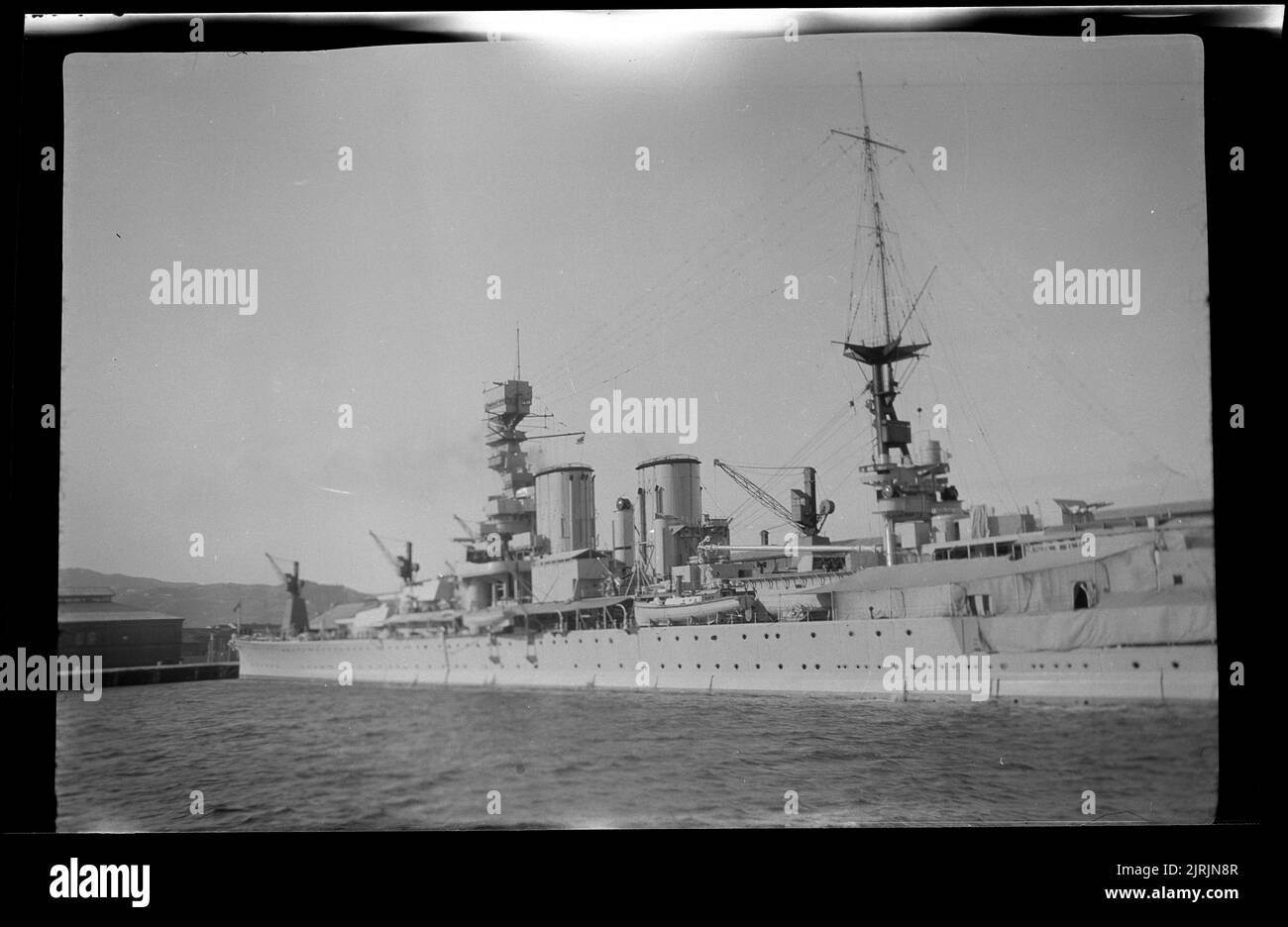 [Battleship moored in Wellington harbour], 1920s-1930s, Wellington, by Roland Searle. Stock Photo