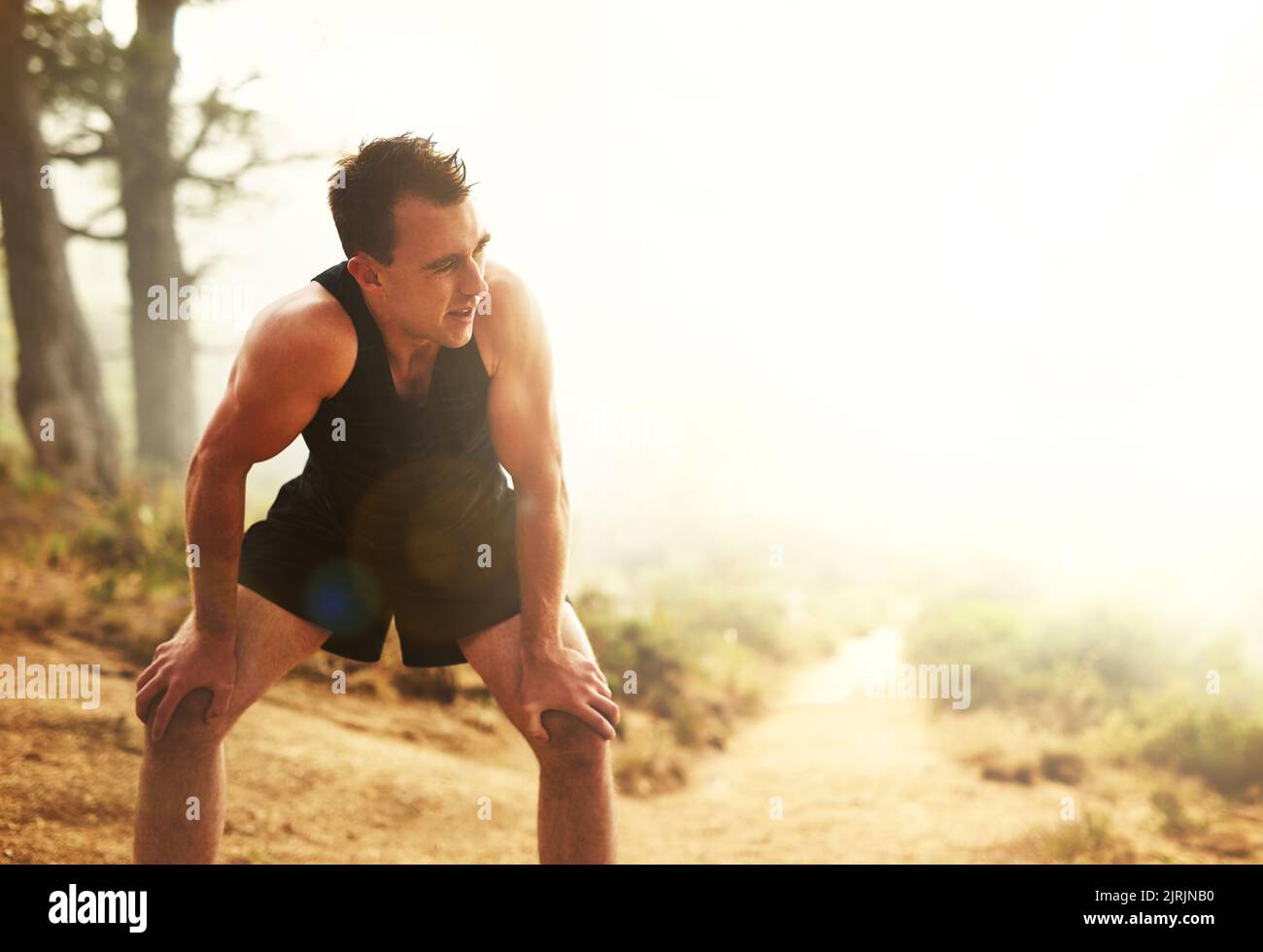 You wont see results if you dont make the effort. a sporty young man taking a break while out for a run. Stock Photo