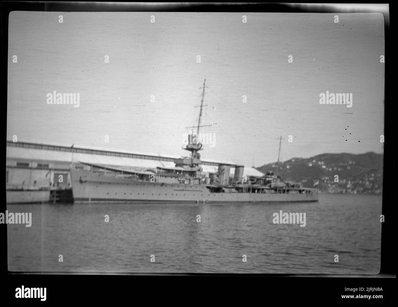 [Battleship moored in Wellington harbour], 1920s-1930s, Wellington, by Roland Searle. Stock Photo