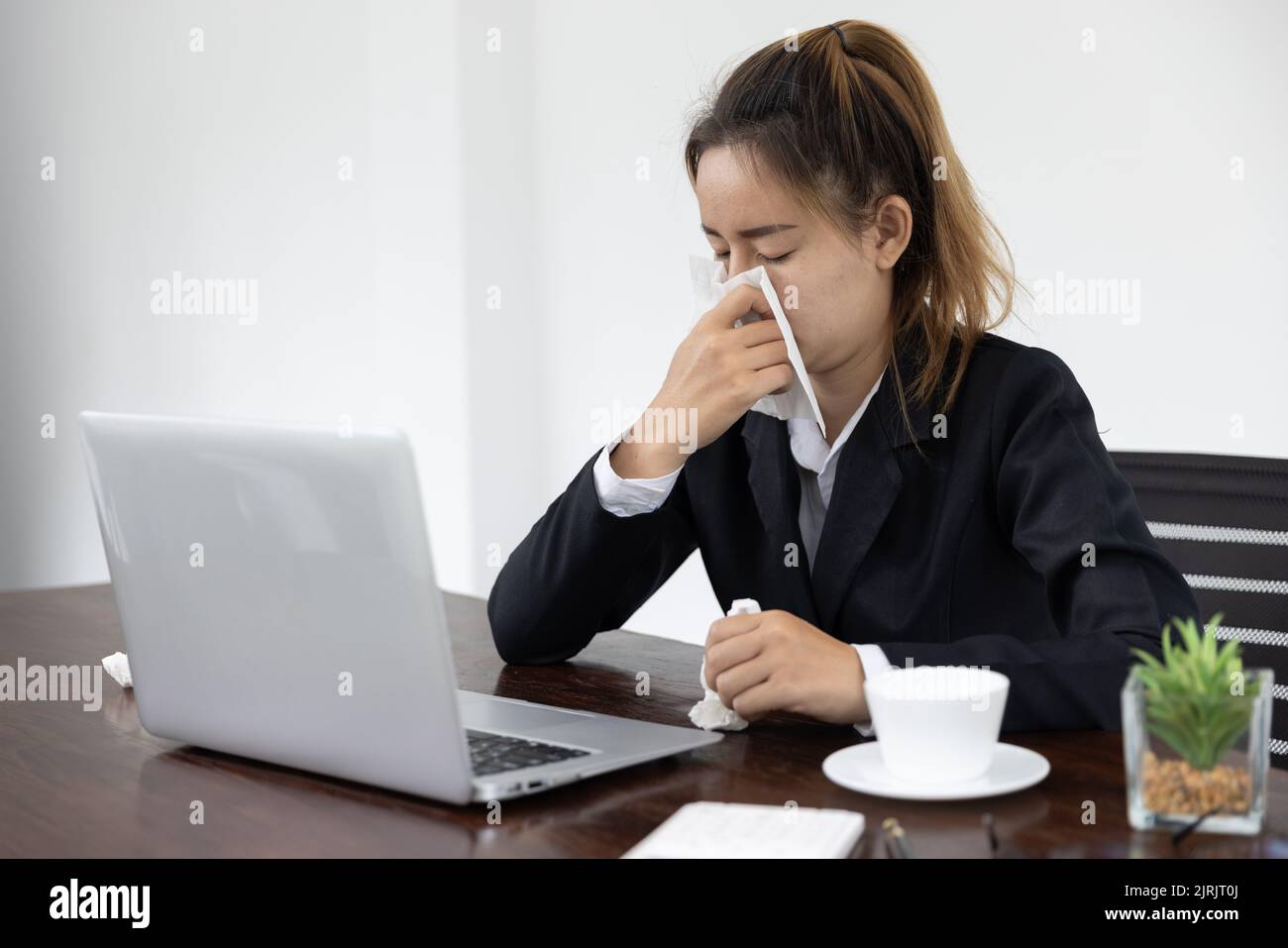 Tired asia business woman with headache at office, feeling sick at work, copy space Stock Photo