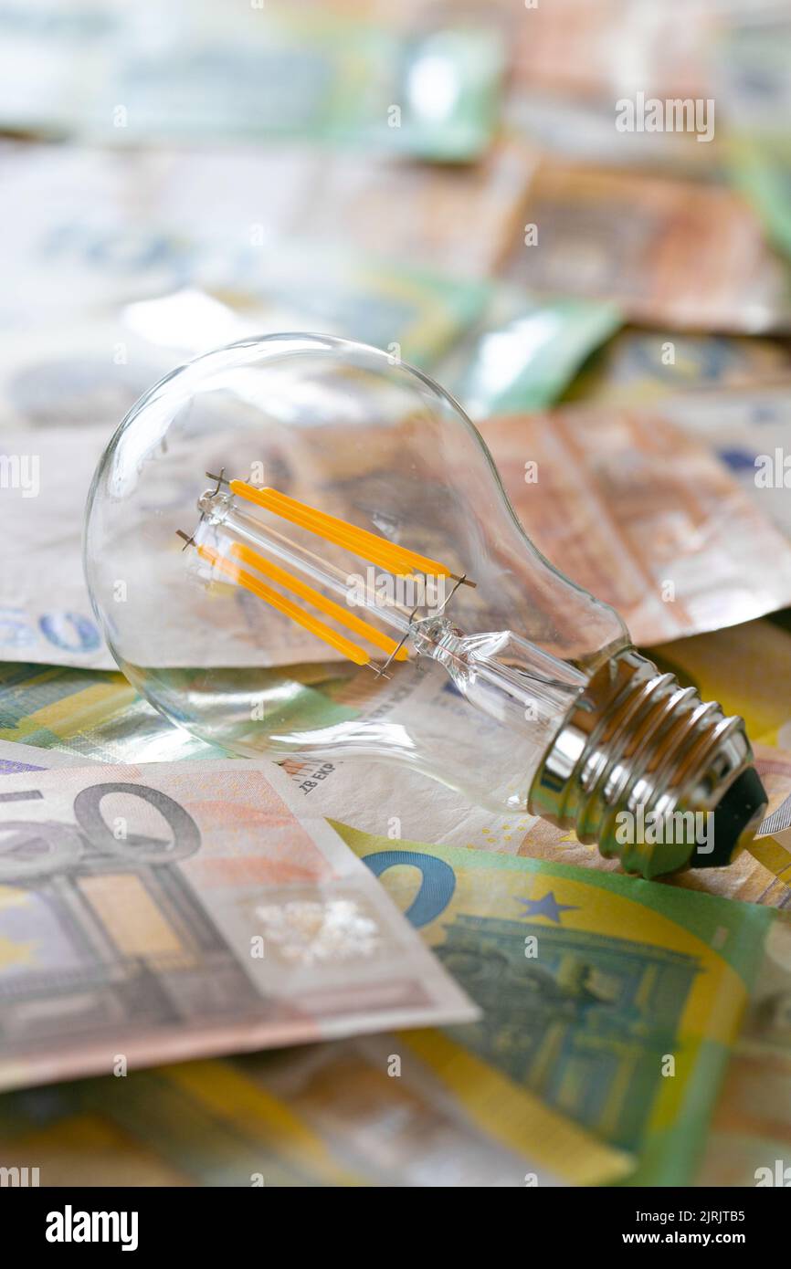 Electricity cost. light bulb on euro bills.Rising electricity prices in