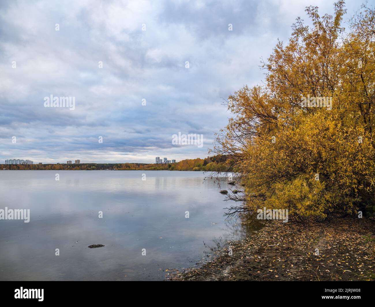 Autumn lake with yellow trees on the shores. Reflection of blue sky ...