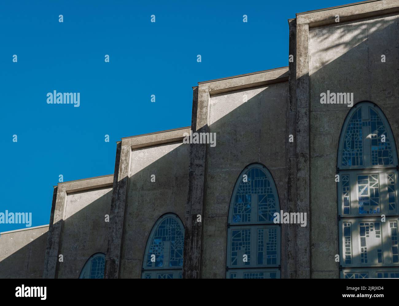 Abstract geometric lines of Facade Details of historic church. Pattern and sculpture, arches. Dark cathedral, looking up to towers, perspective. Westm Stock Photo