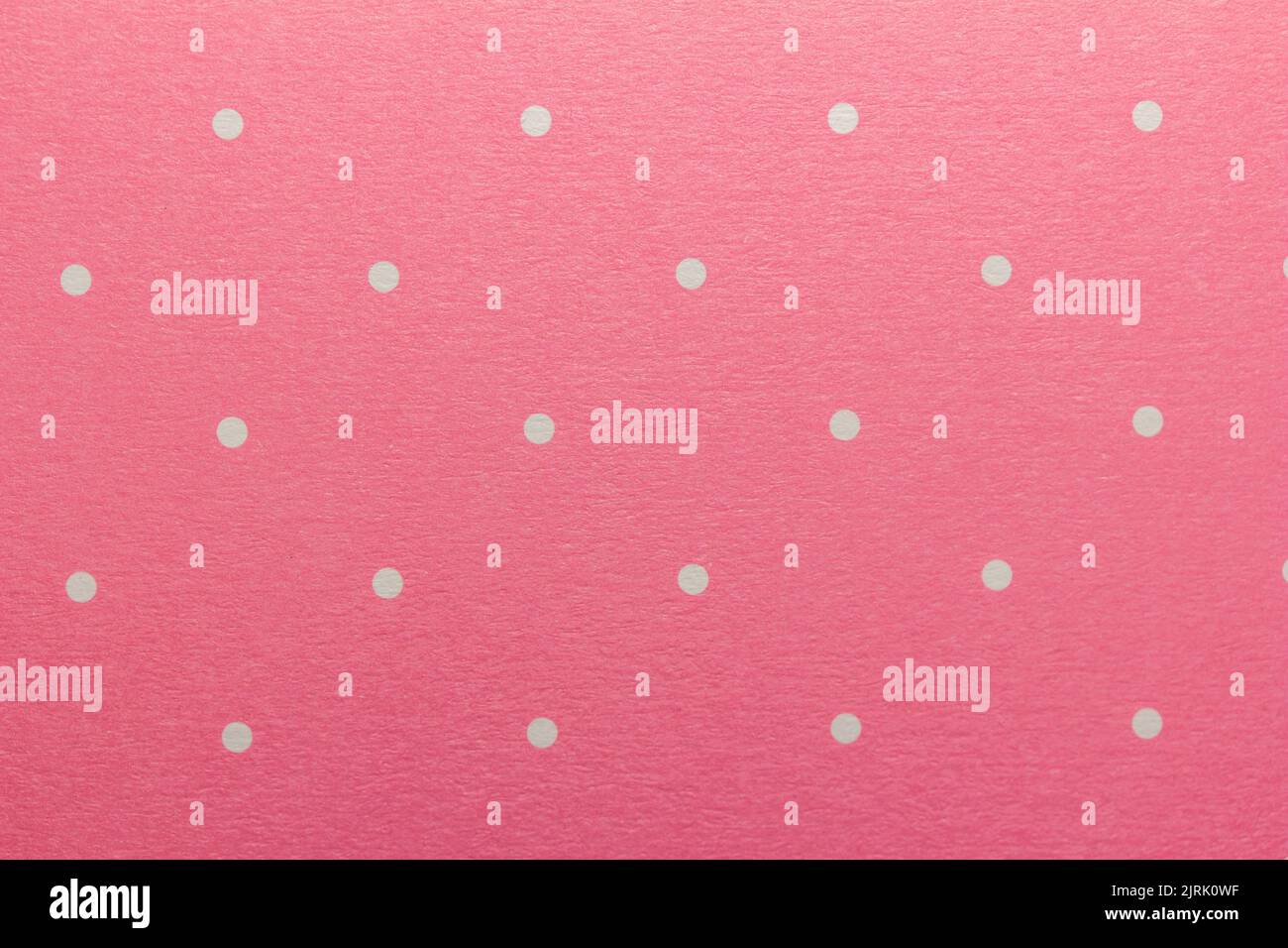 Full frame abstract texture background of solid pink and white polka dots pattern with selective focus Stock Photo