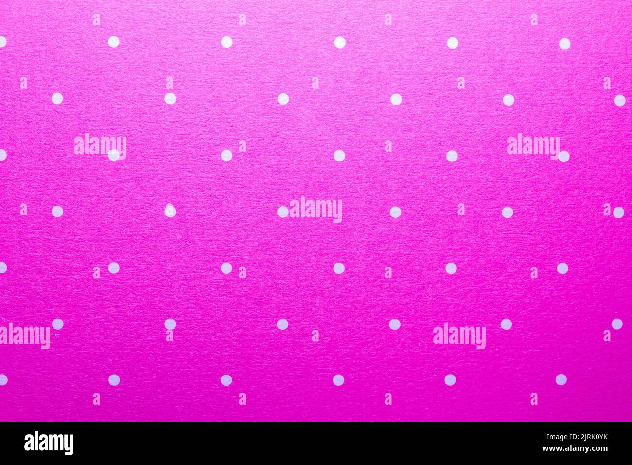 Full frame abstract texture background of solid pink and white polka dots pattern with selective focus Stock Photo