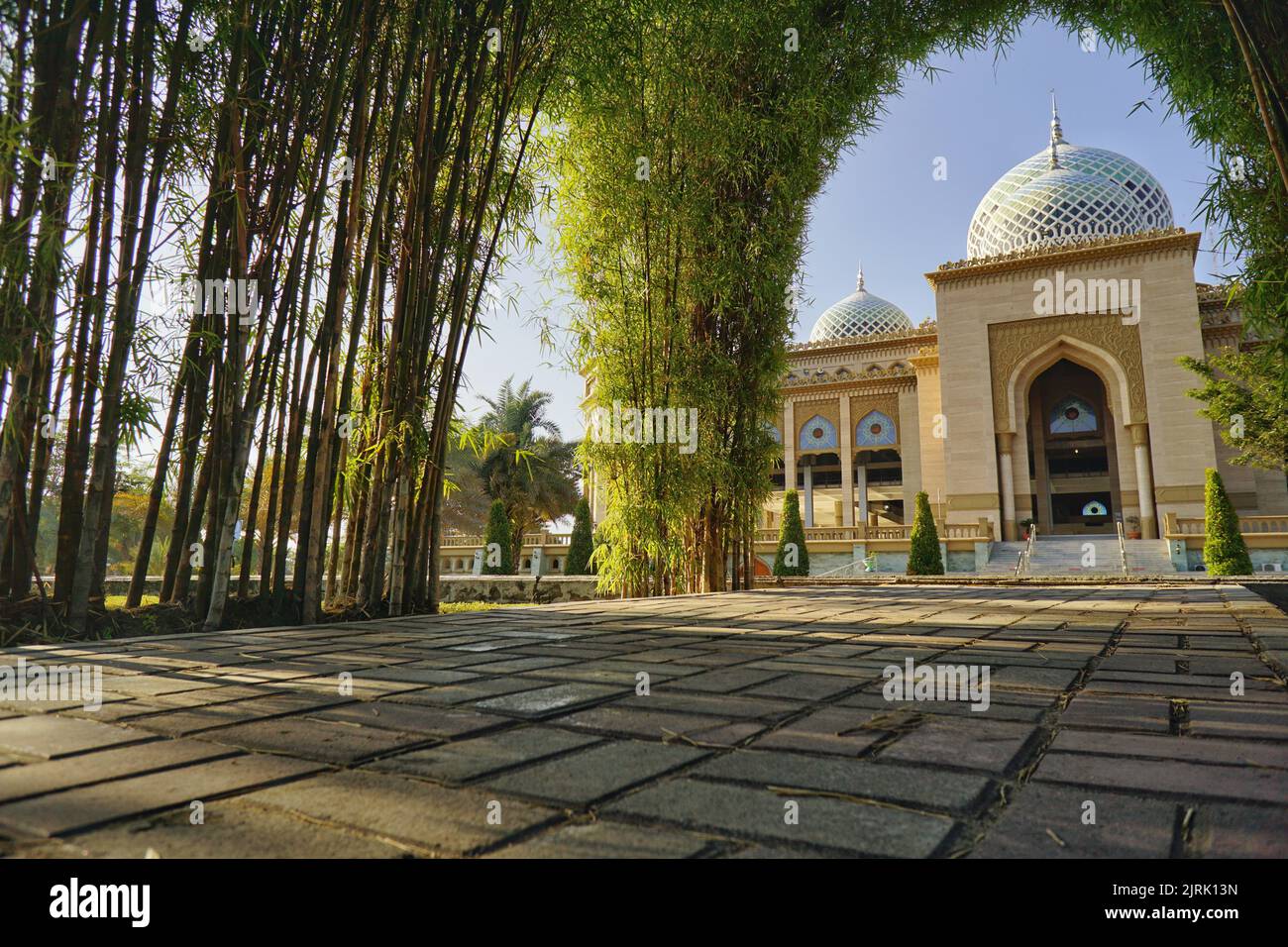 Beautiful mosque with bamboo tree frame . Islamic Center Mosque in Lhokseumawe Stock Photo