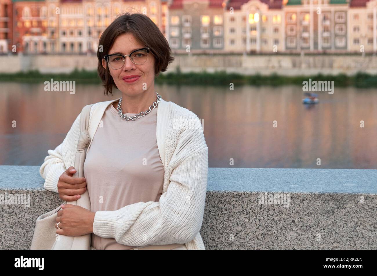 Portrait of a girl on the embankment of the river Stock Photo - Alamy