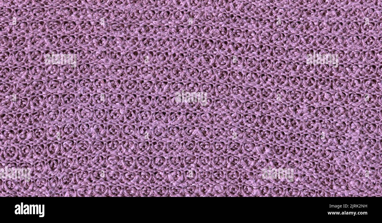 Magneta knitted background with copy space. Fabric purple lavender colored colored texture for background and design. Stock Photo