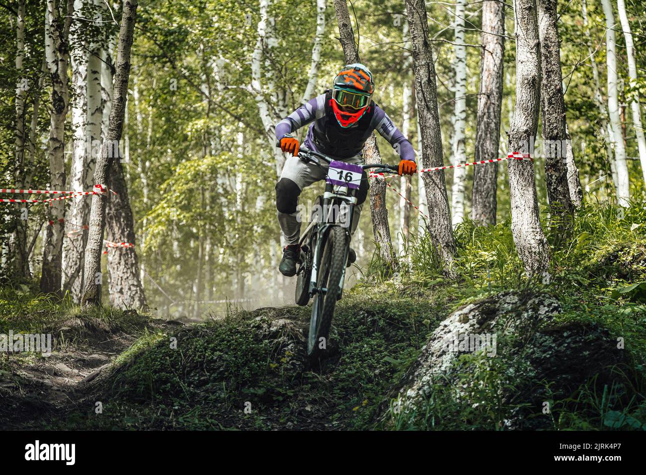 athlete rider riding forest trail in downhill race Stock Photo