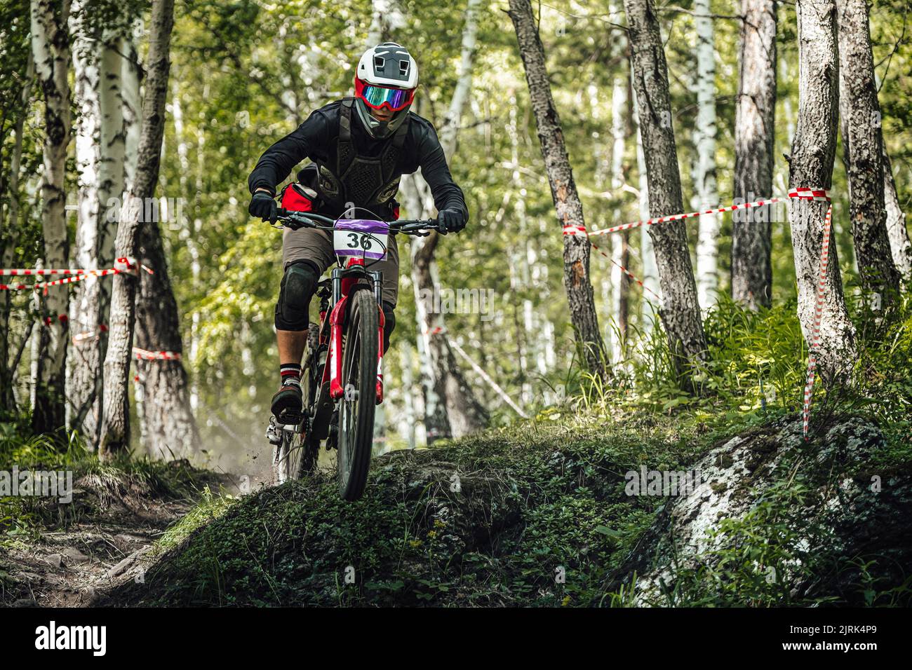 athlete rider downhill forest trail race Stock Photo